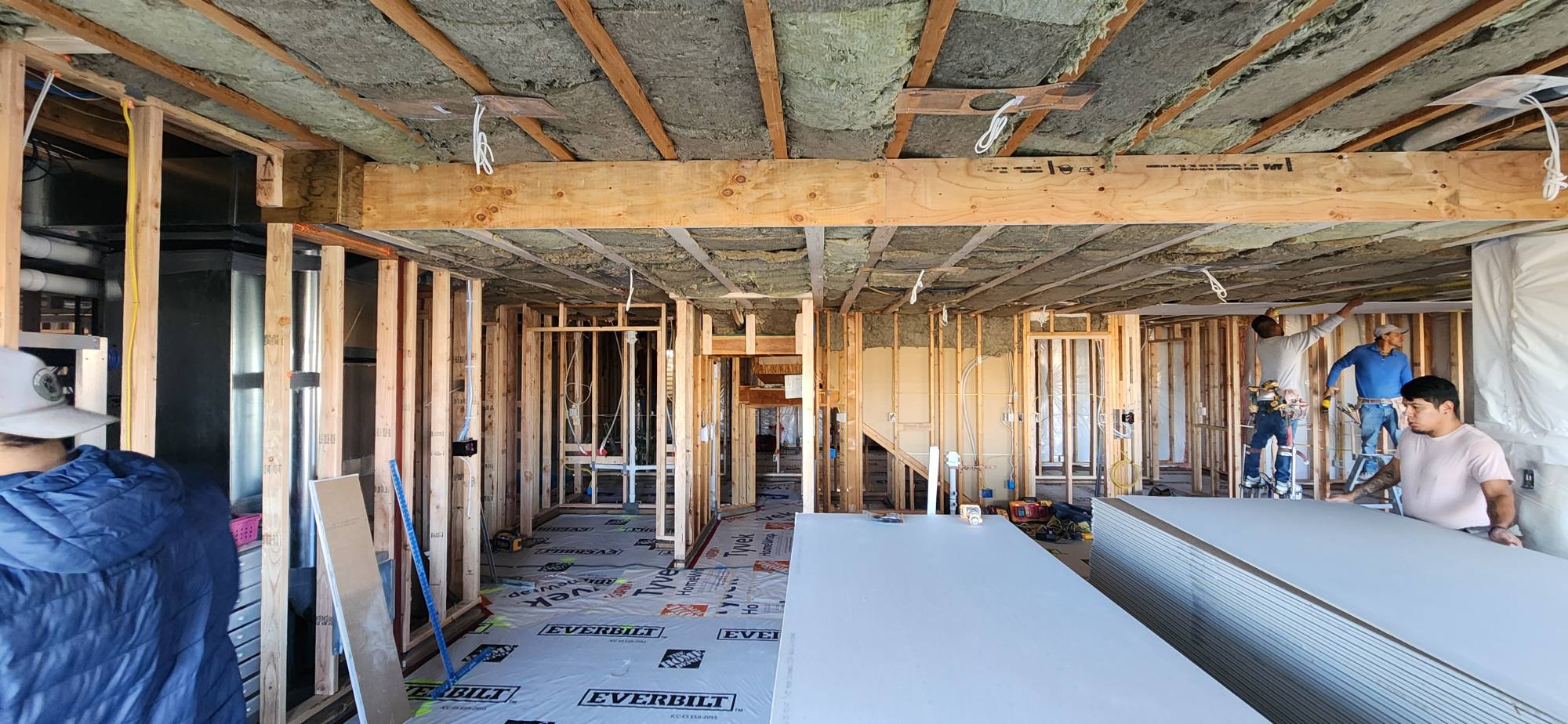 Crew hanging drywall on large remodel project