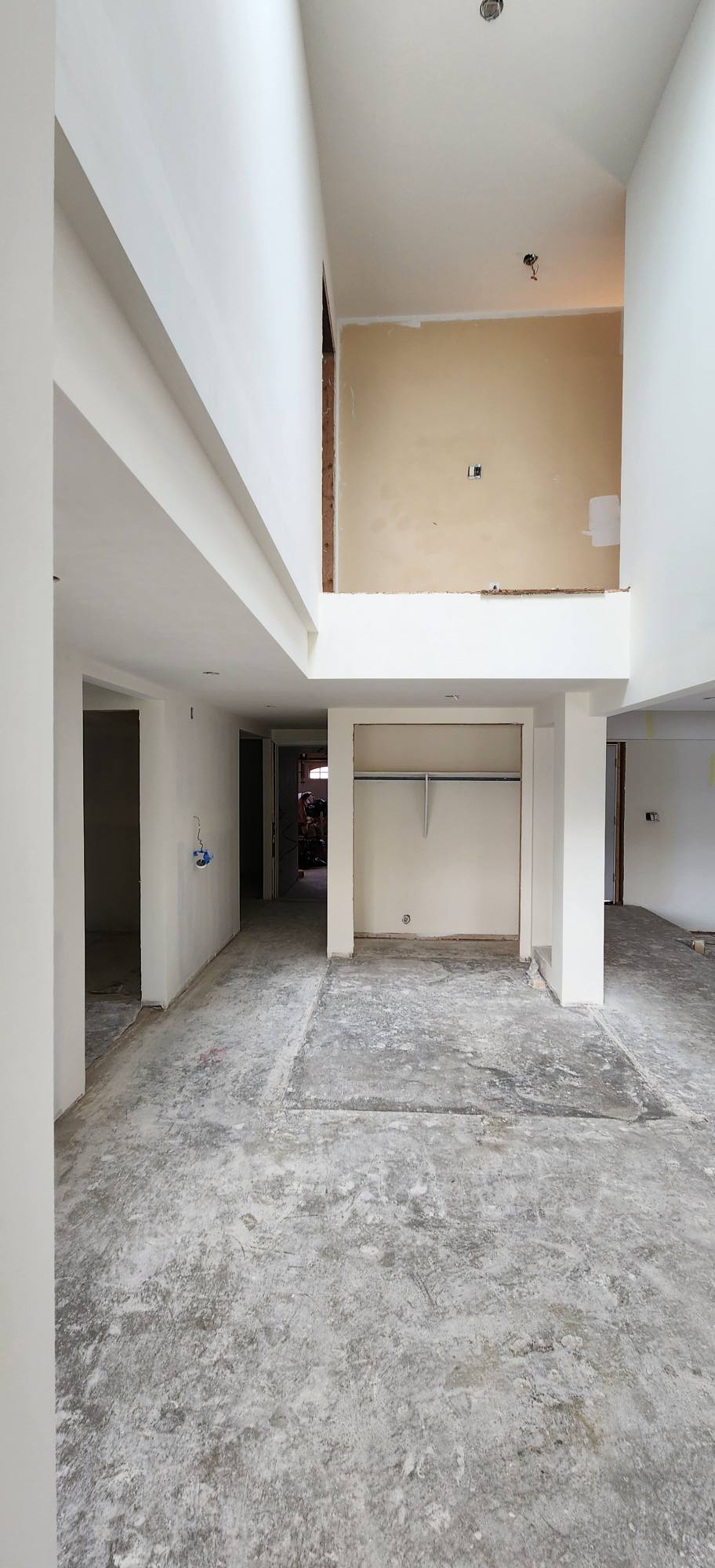 Large-scale drywall installation with tall ceilings