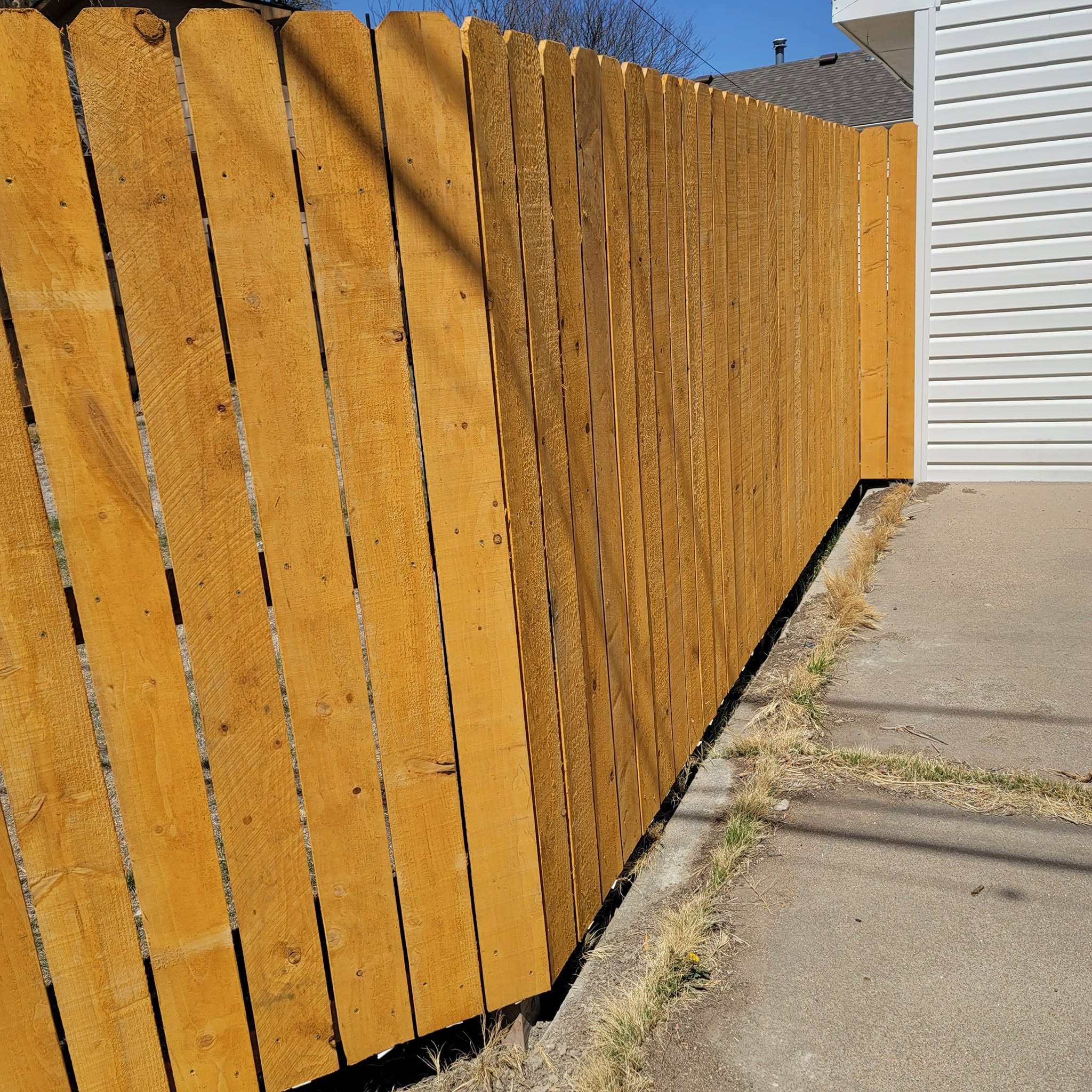 Honey-stained wooden privacy fence