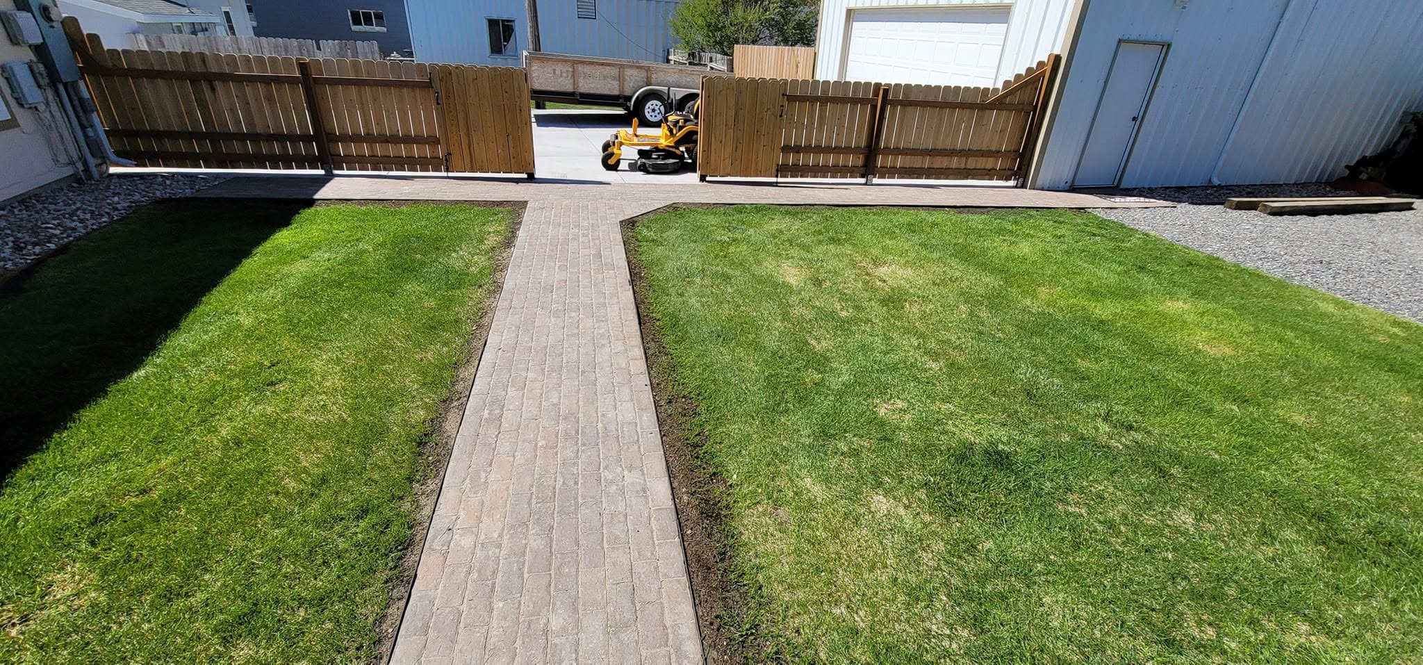 Symmetrical lawn with wood plank pathway