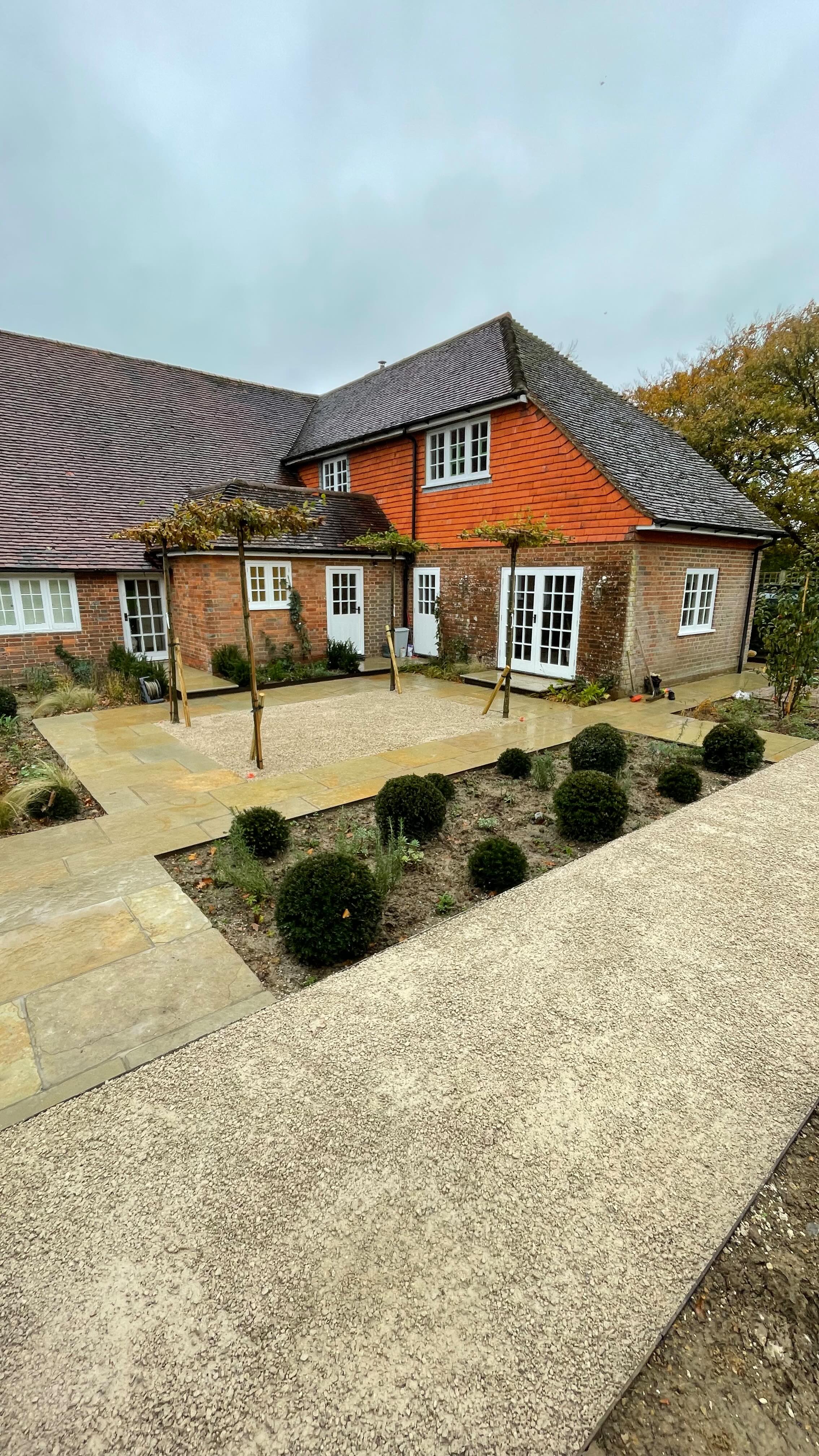 Limestone paving with reclaimed brick accents