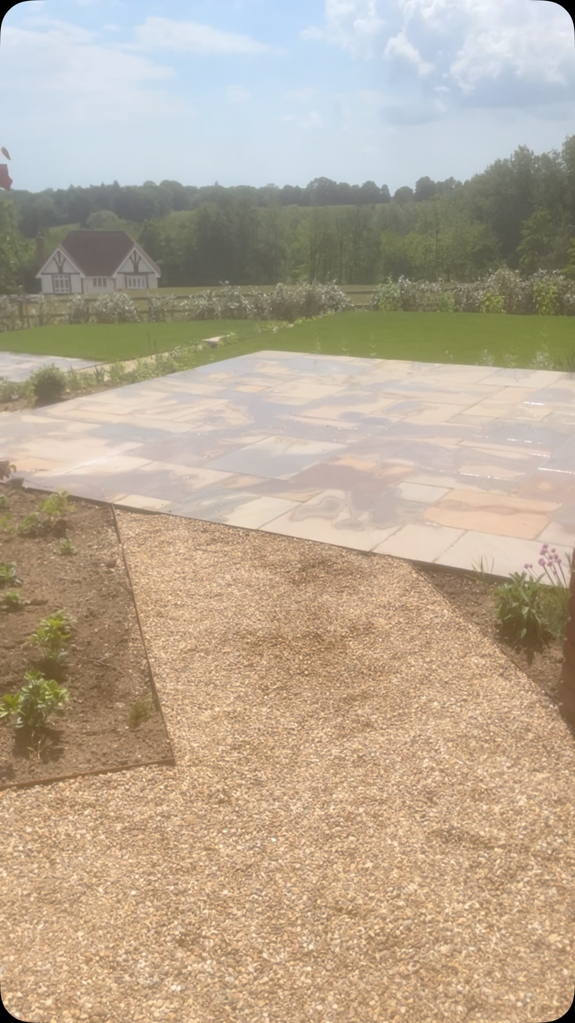 Paved driveway with gravel pathways