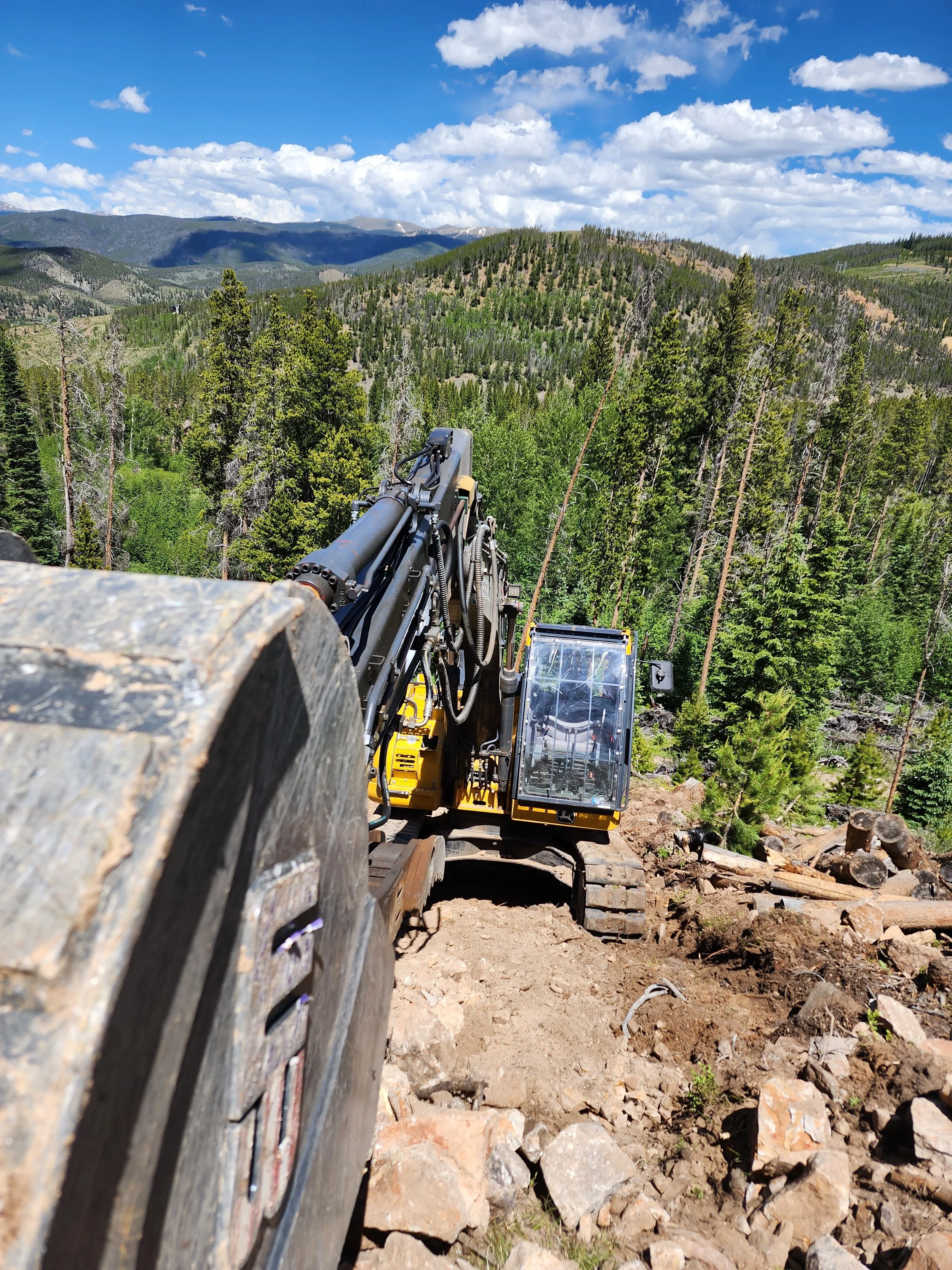 Bulldozer working on a rocky mountain trail