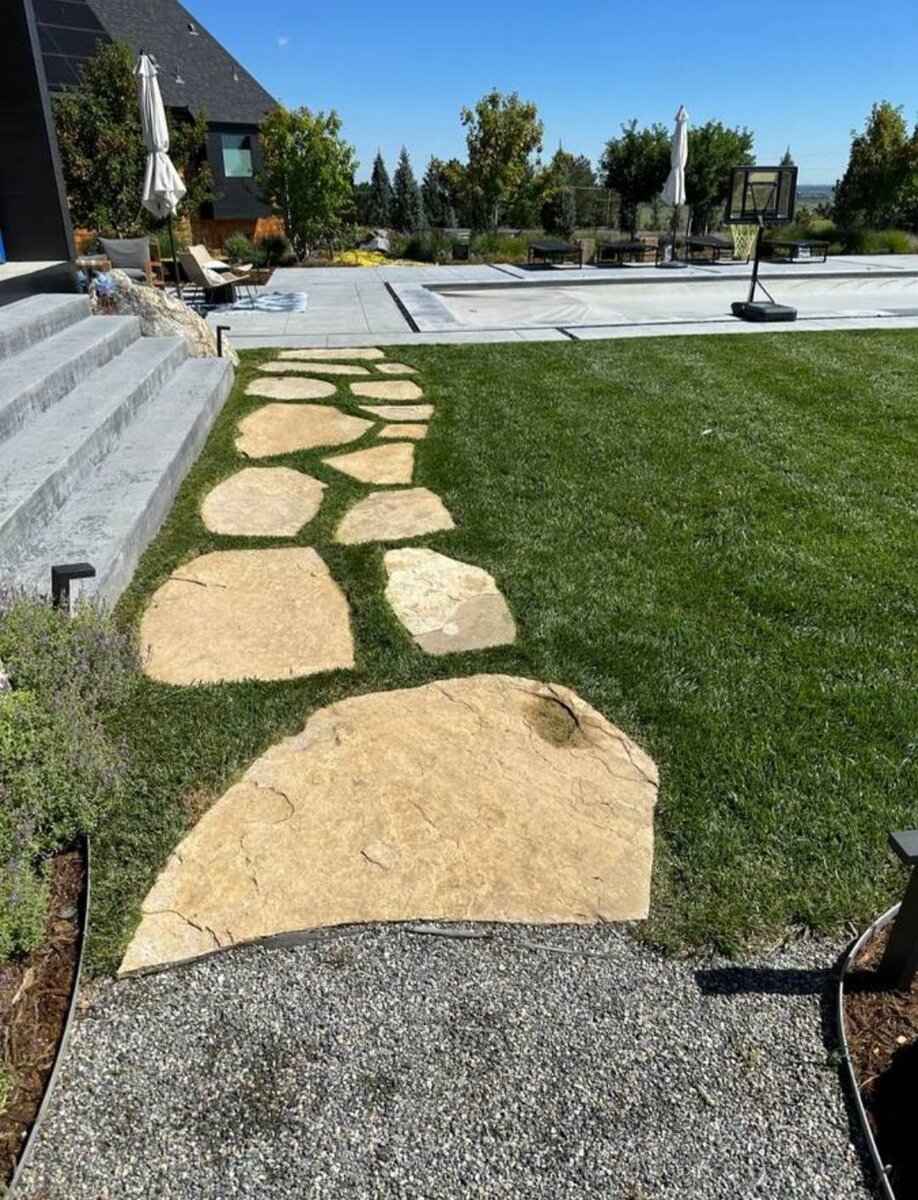 Stepping-stone path across a freshly maintained lawn