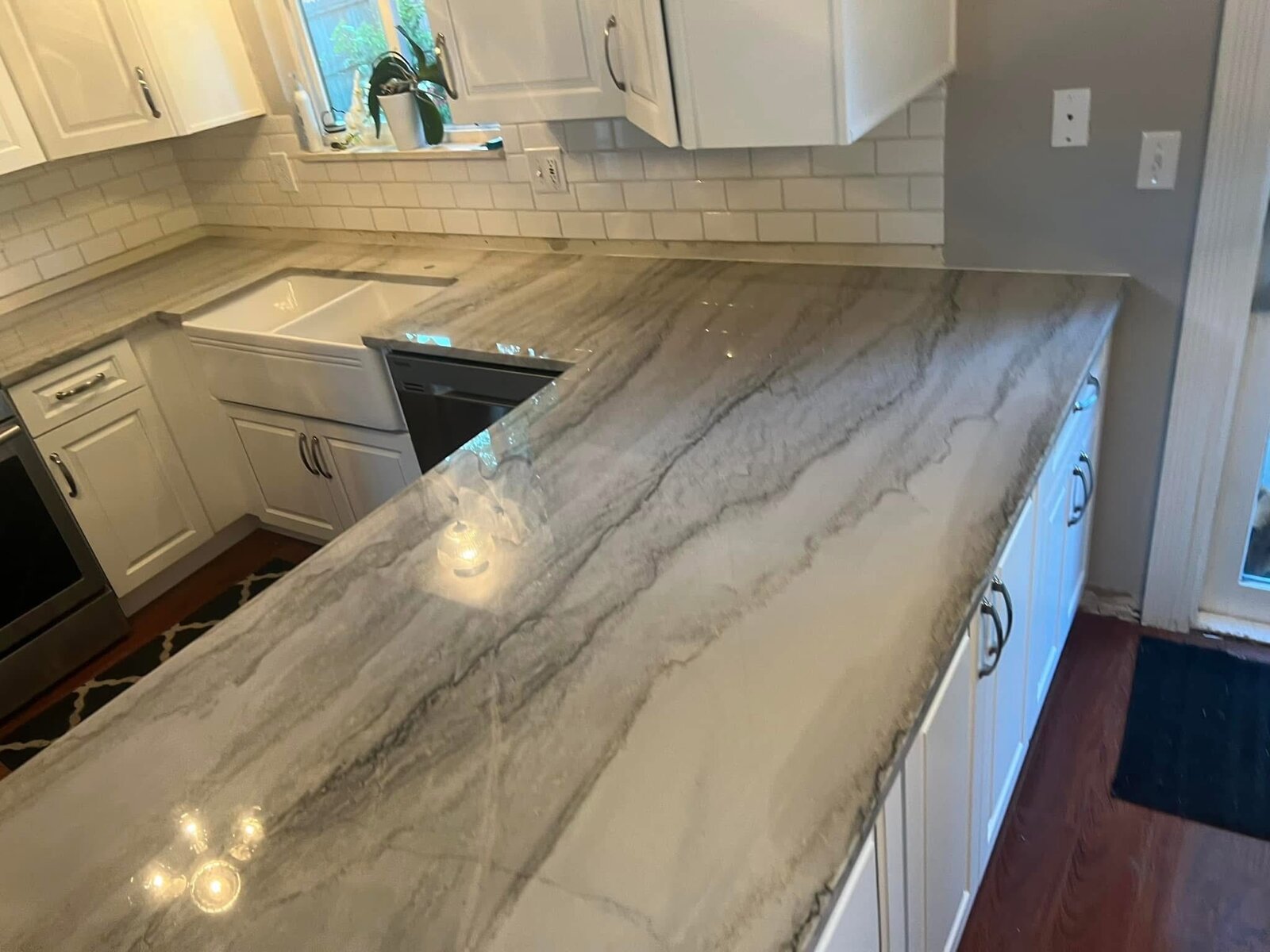 Gray quartzite kitchen with subway backsplash