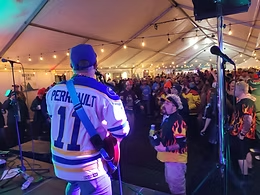 Live band playing to a packed crowd in the Après Ice Party tent