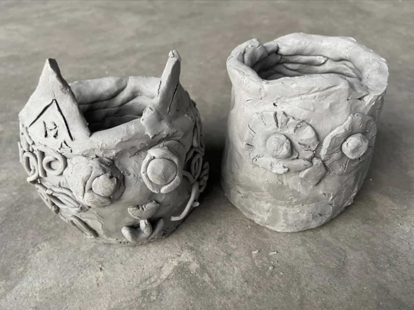 Hand-built clay vessels with floral relief