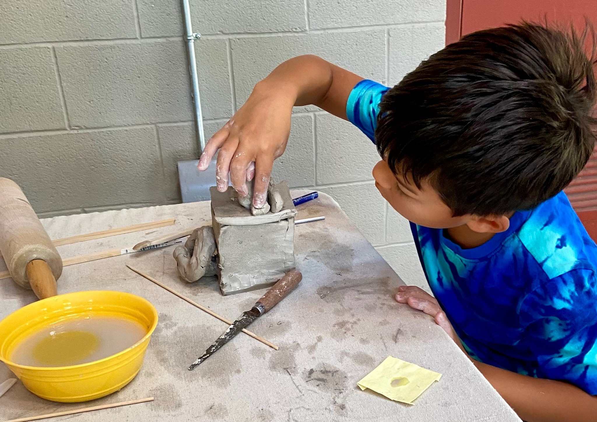 Student working with clay at Planet Picasso studio