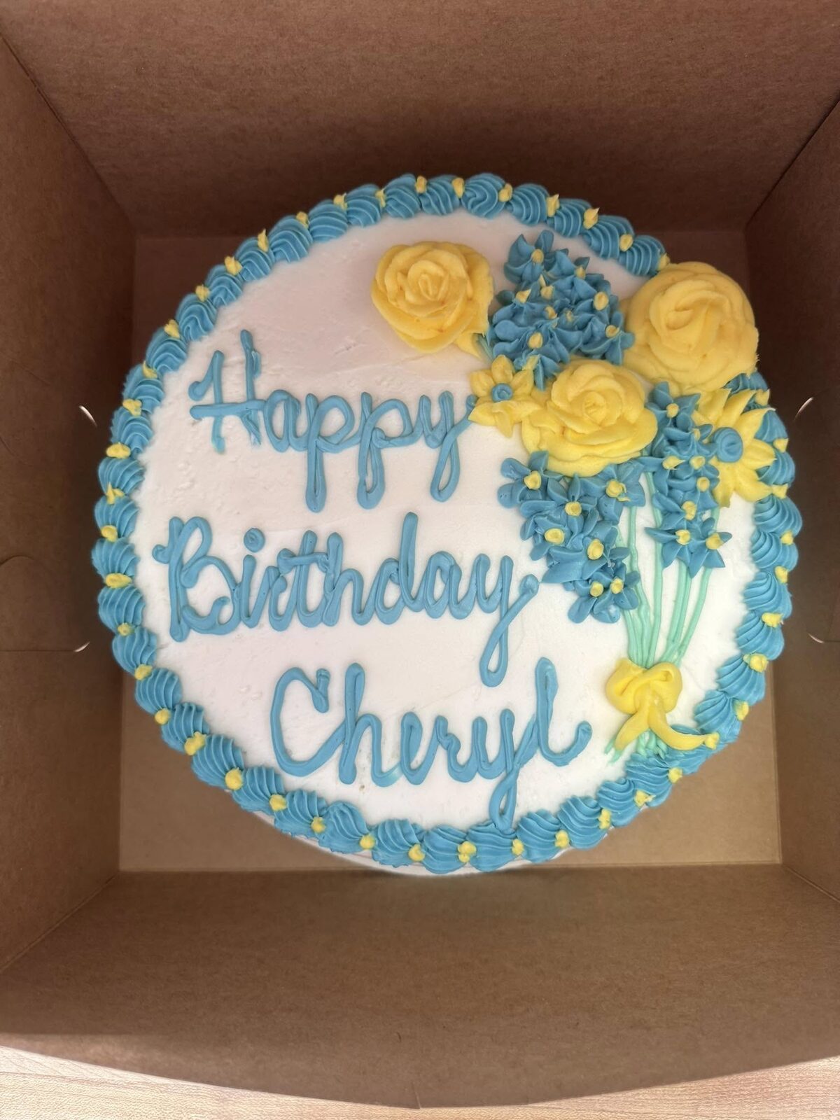 Birthday cake with turquoise border and fondant flowers