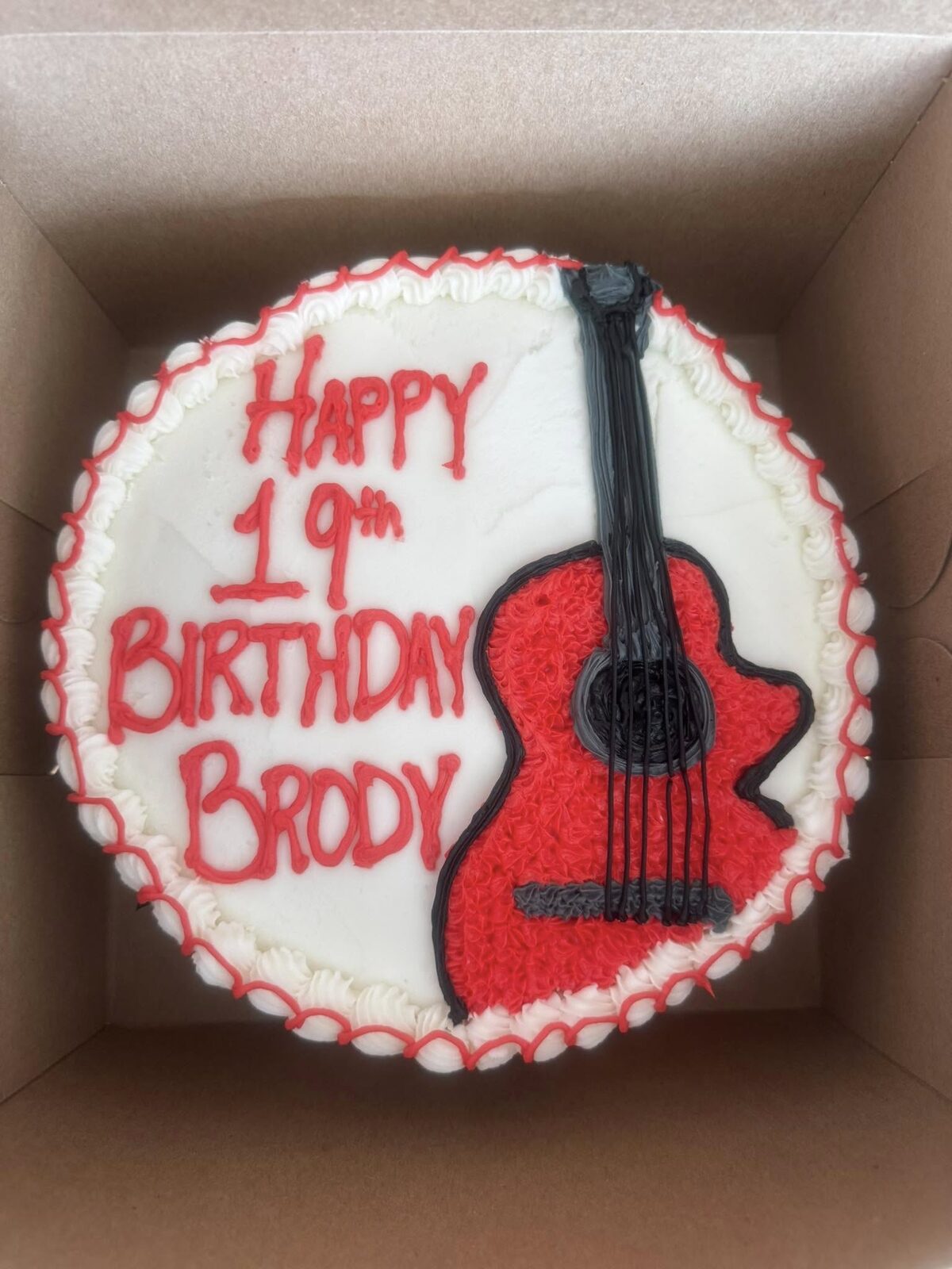 Birthday cake with a red fondant electric guitar