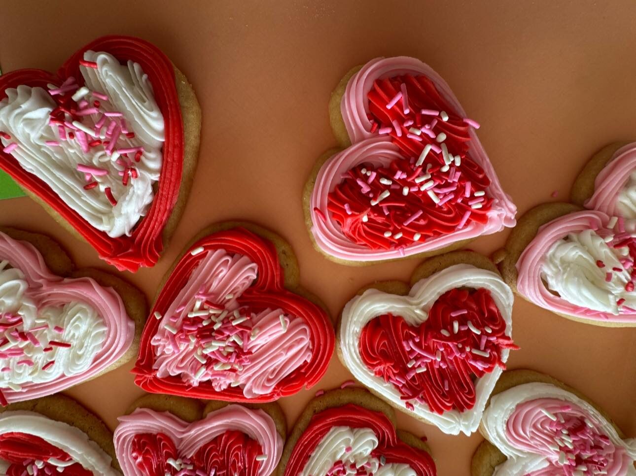 Red velvet heart-shaped cakes with white frosting