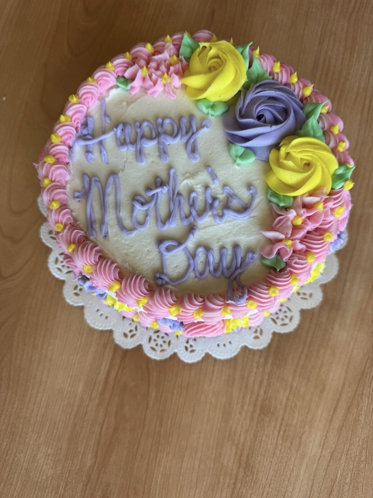 Round cake covered in colorful buttercream rosettes