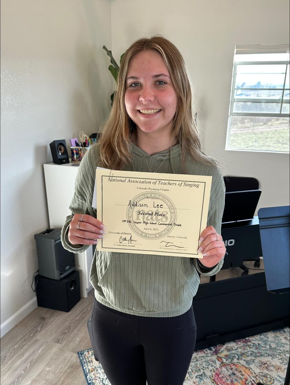 Student holding NATS Student Auditions certificate