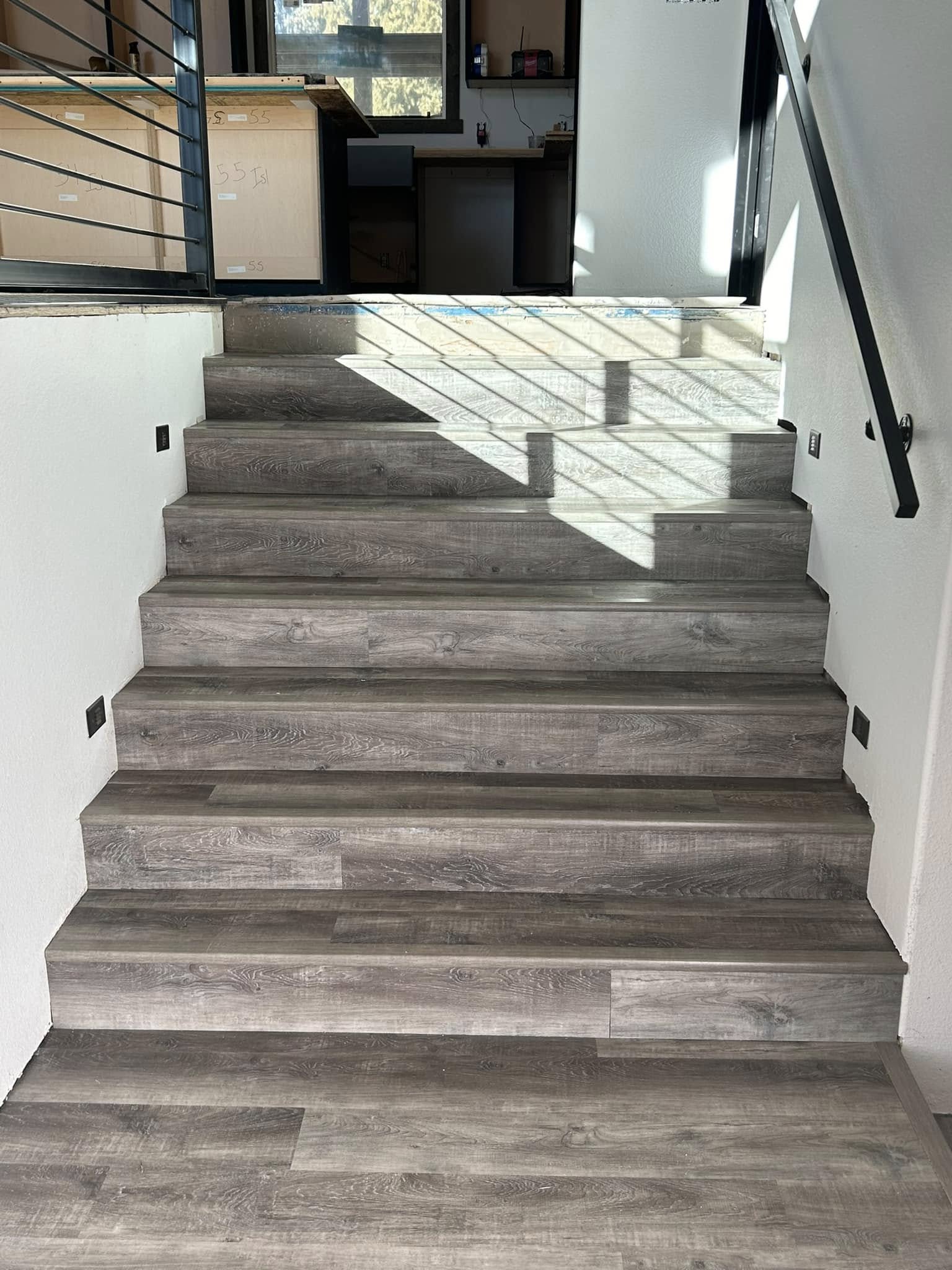 Staircase with gray wood-look plank flooring