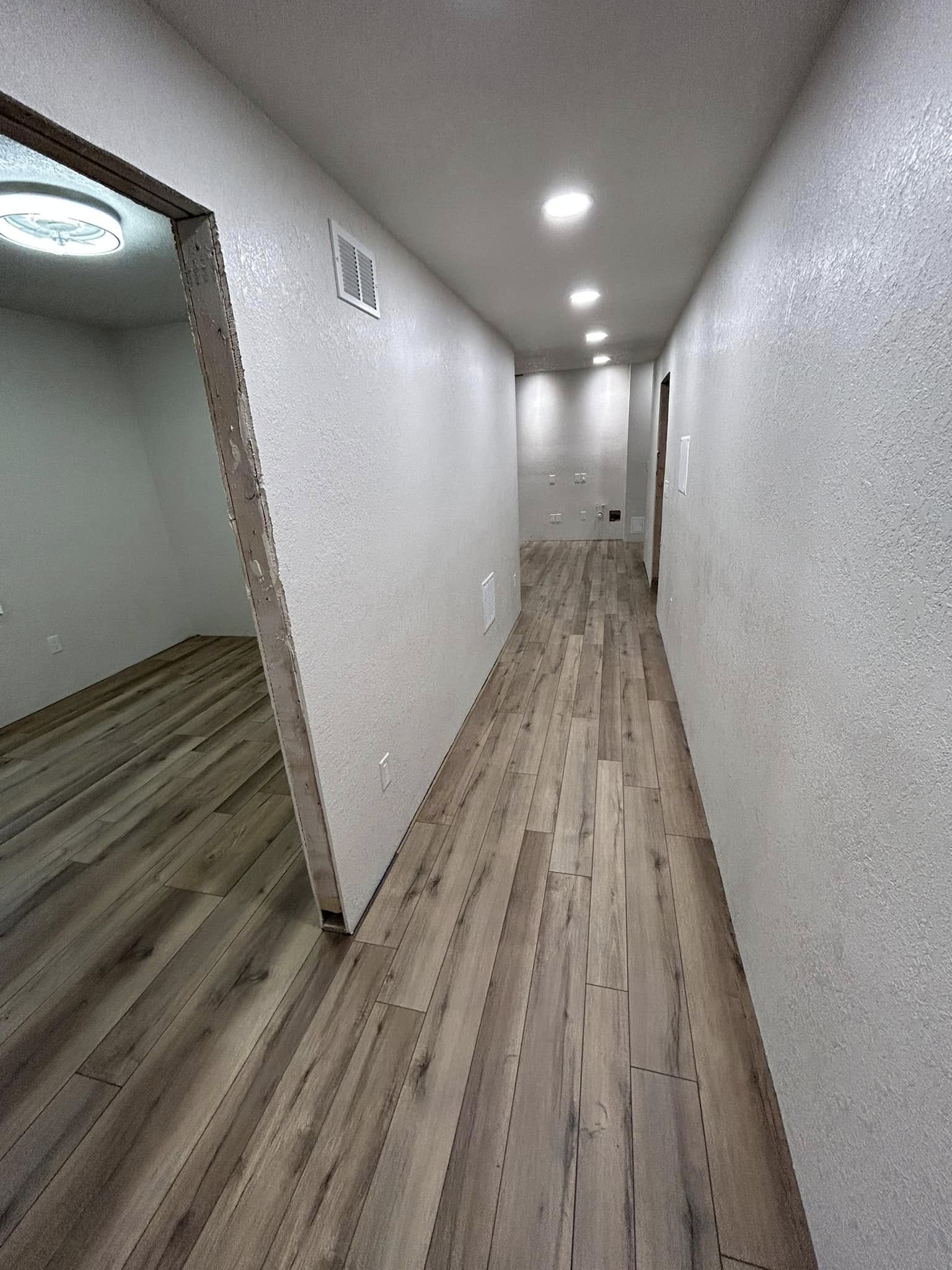 Hallway with installed wood-look plank flooring