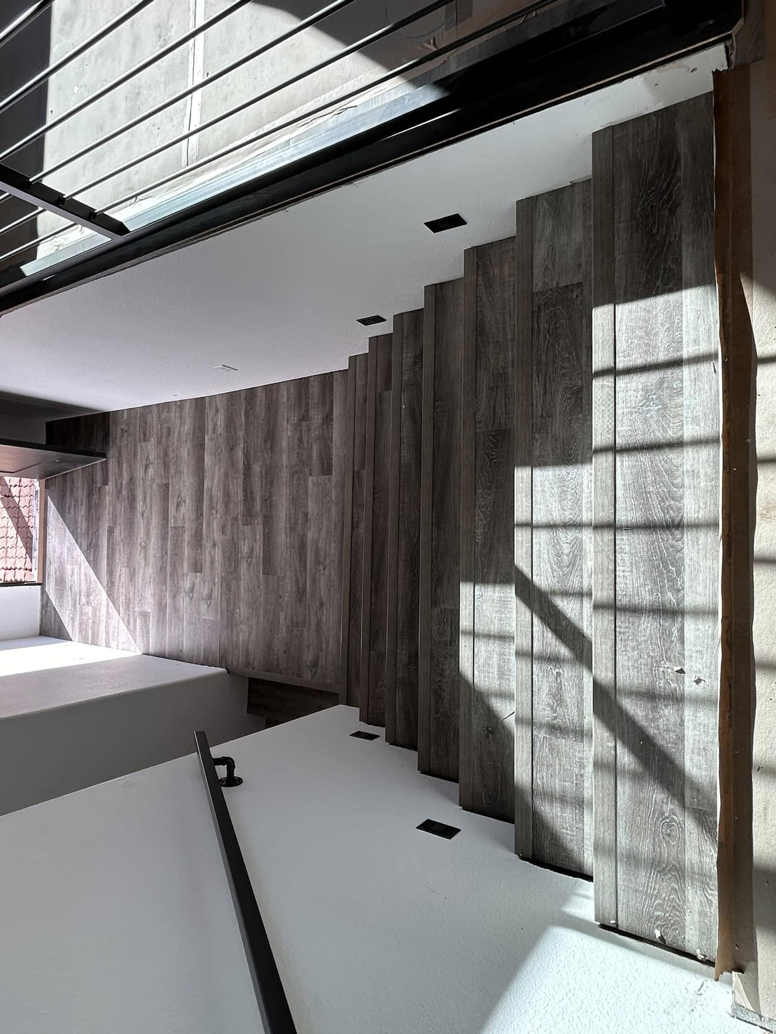 Room interior with wood-look plank flooring and accent walls
