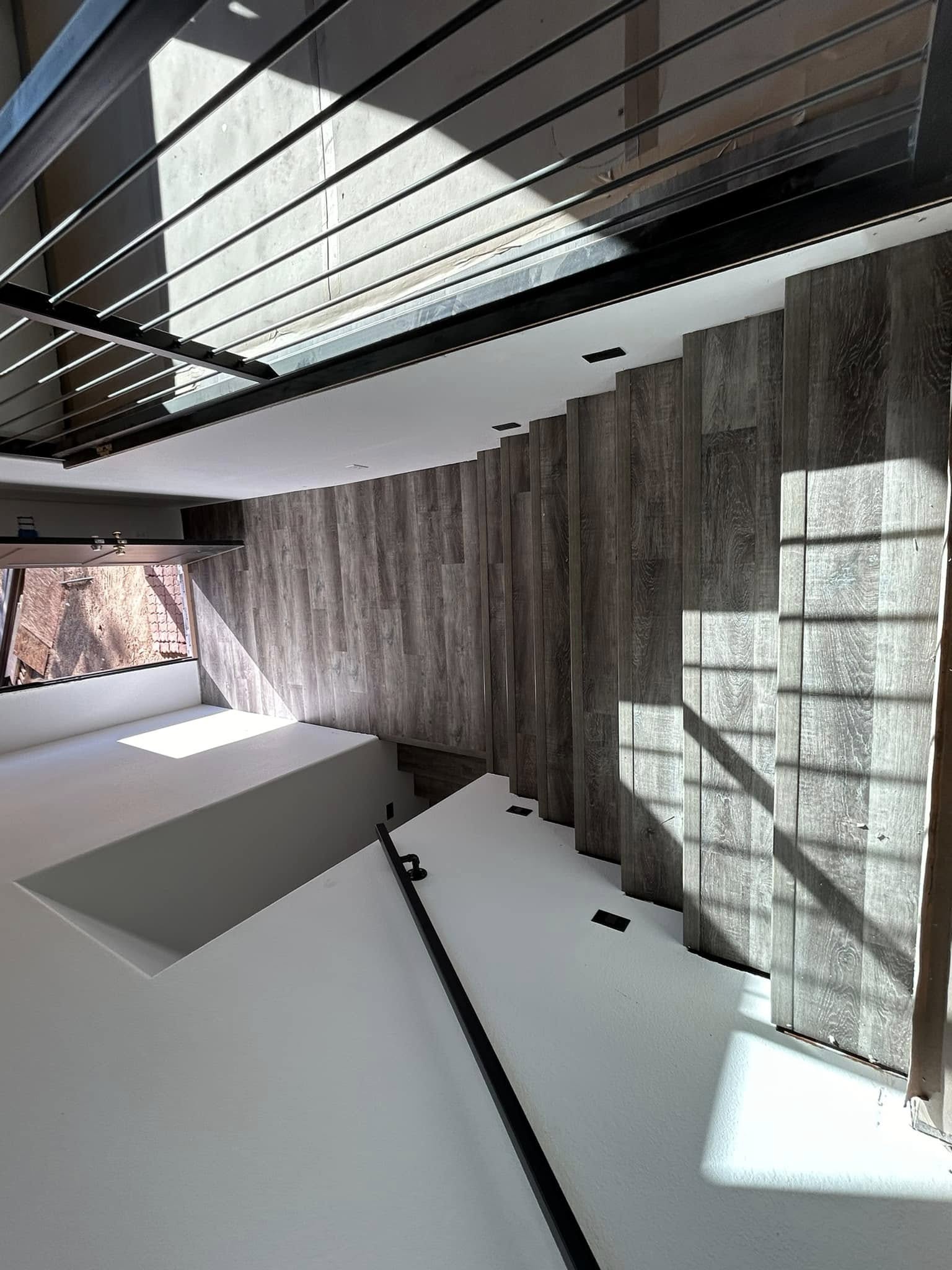 Multi-level interior with wood-look plank flooring and wall treatments