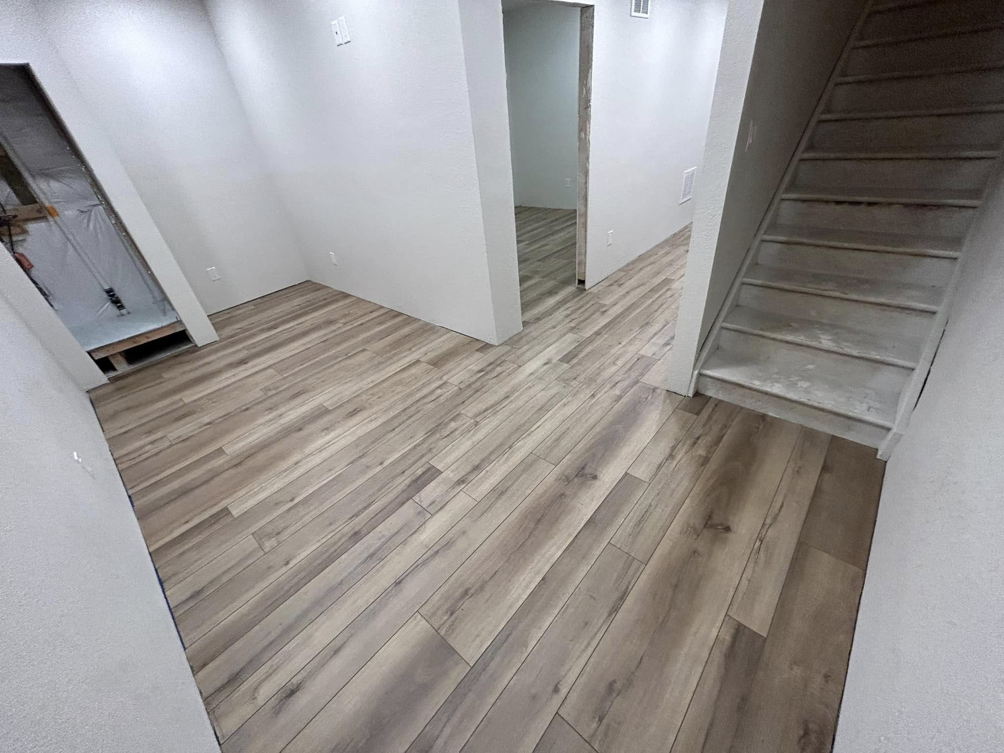 Room corner with light wood-tone plank flooring