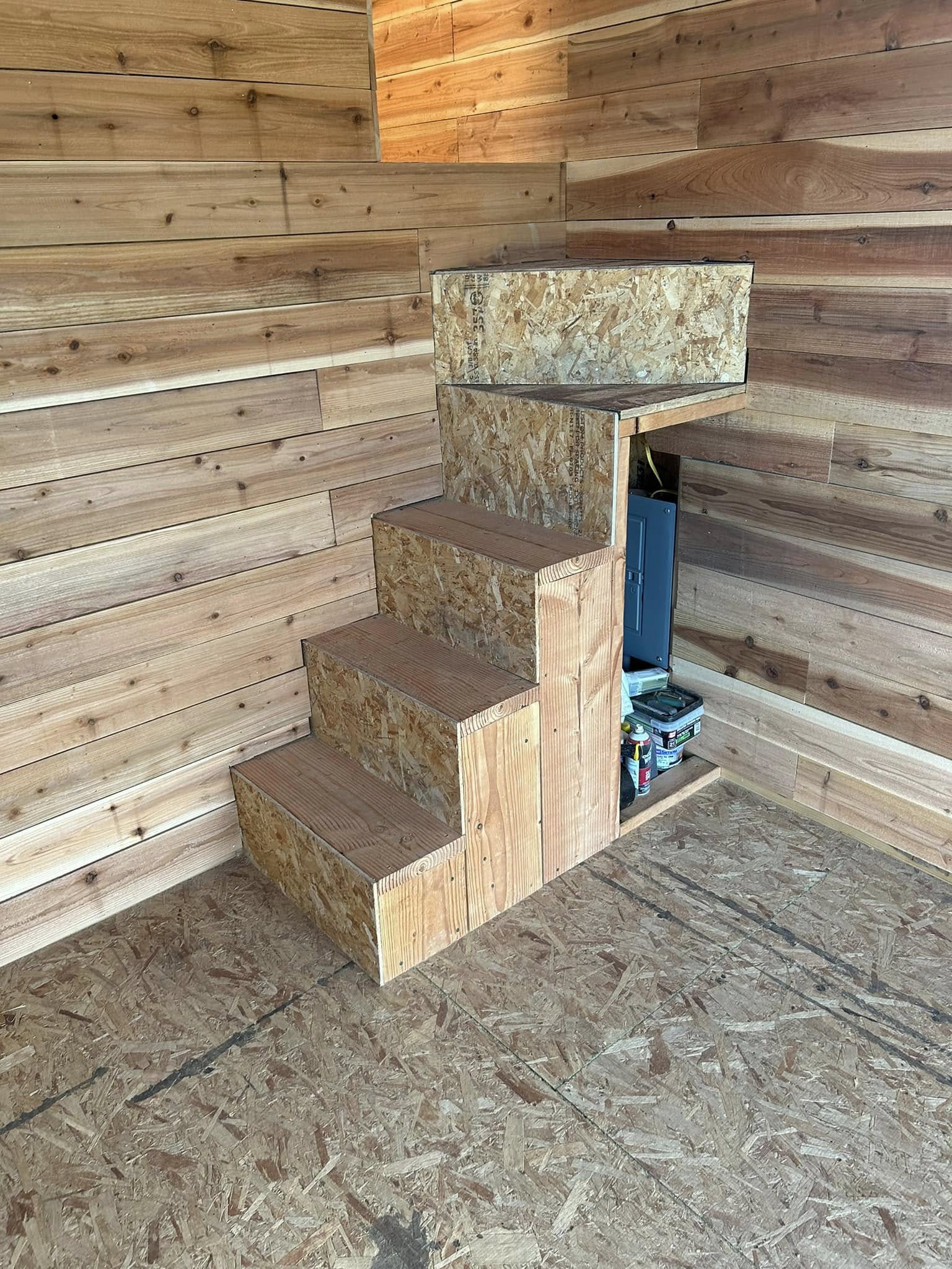 Interior framing with stacked building materials over exposed subfloor