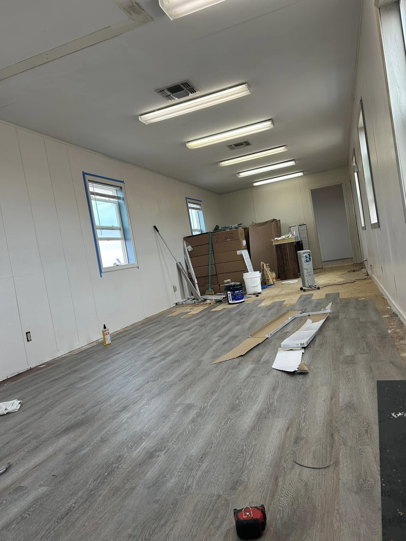 Commercial-scale interior with light wood-tone plank flooring