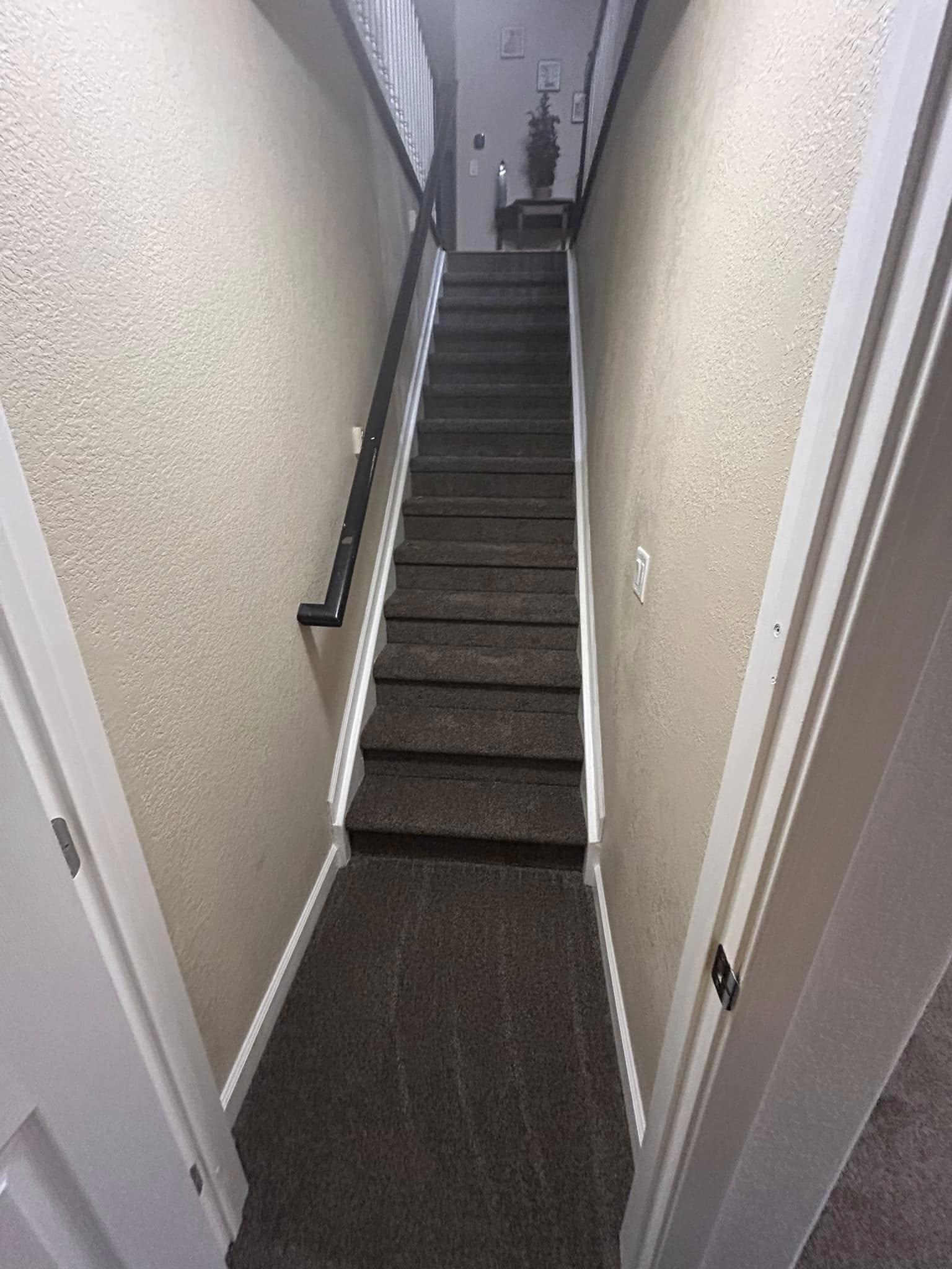 Staircase with dark wood-tone plank flooring